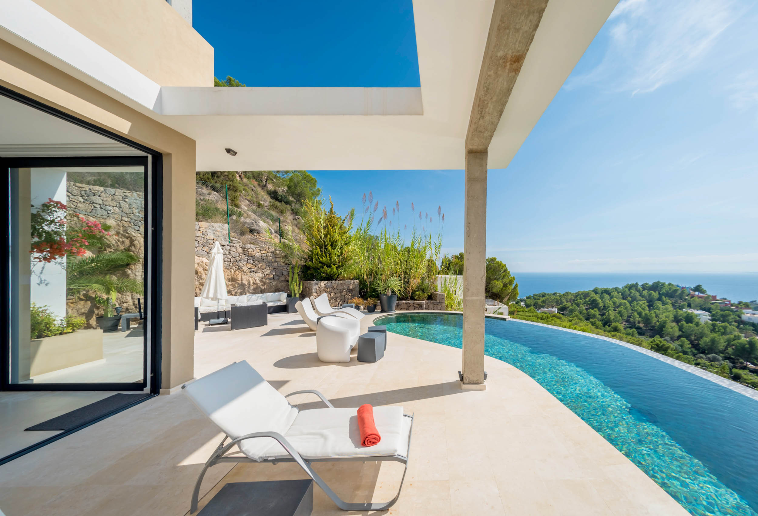 The swimming pool of the Hilltop Villa overlooks the beaches of Ibiza.