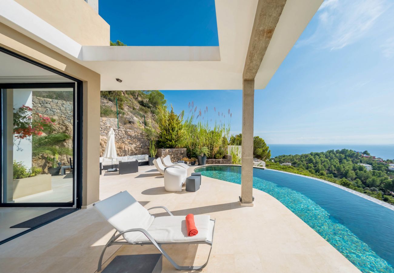 The swimming pool of the Hilltop Villa overlooks the beaches of Ibiza.