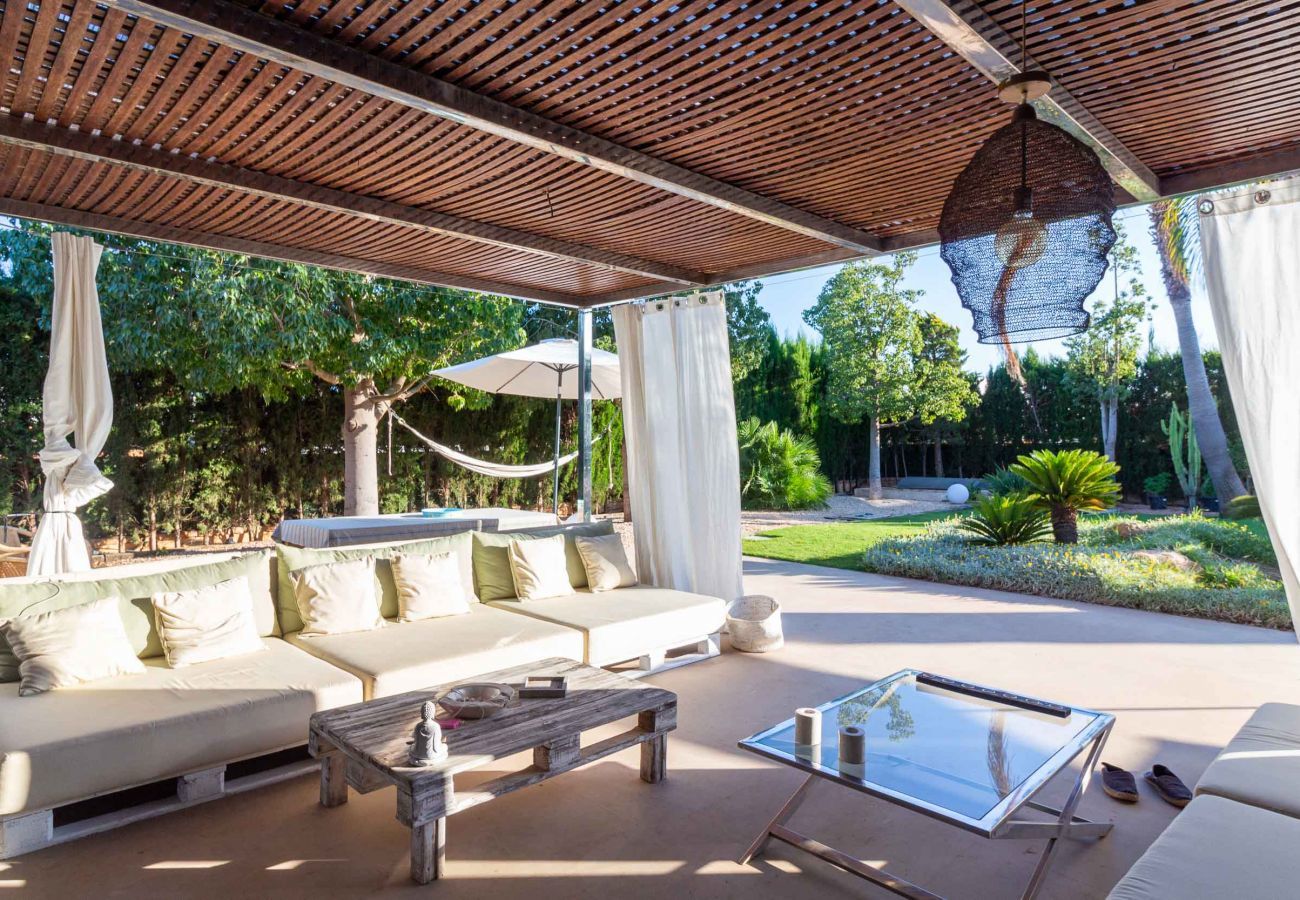 Relaxation area with sofas on the covered terrace of Can Cool