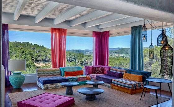 Bright living room with designer sofas and mountain views