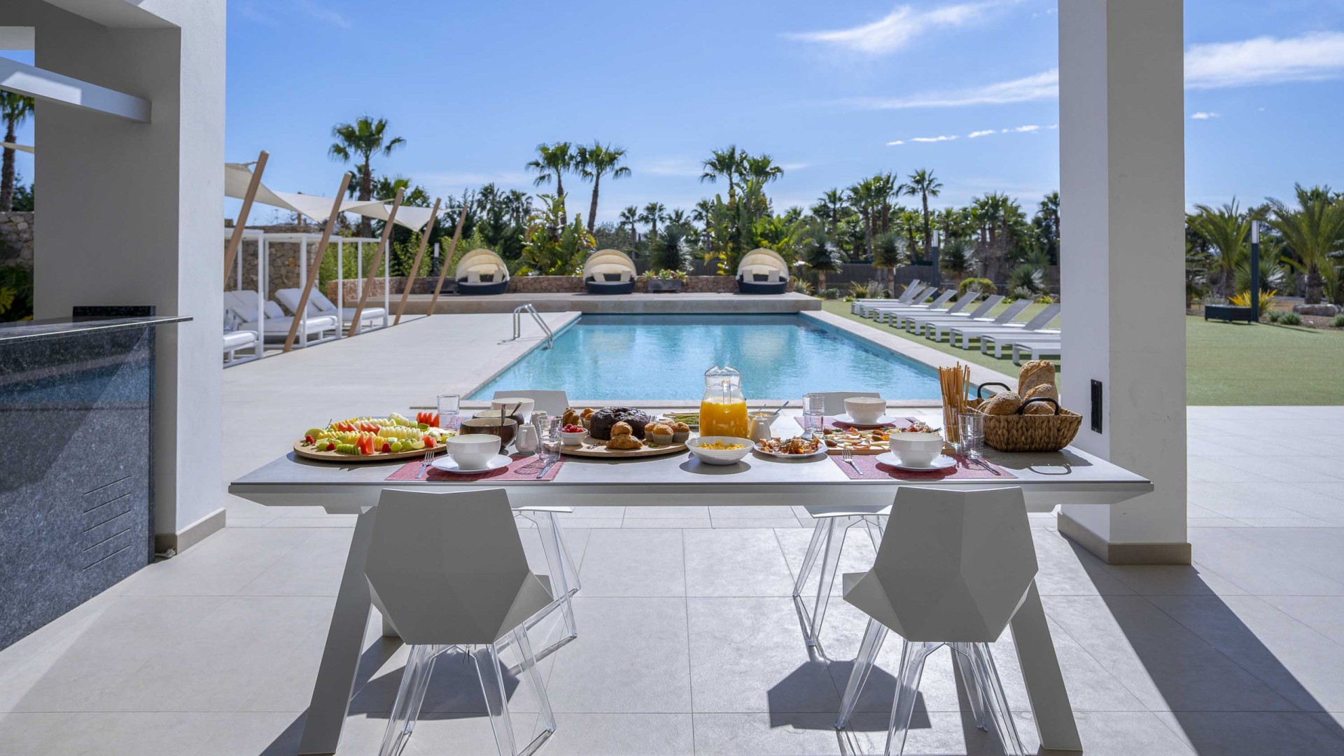 Mesa de desayuno junto a la piscina en Villa Remus